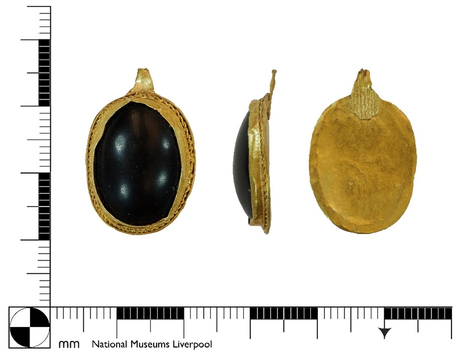 A mostly complete gold pendant with large garnet setting dating to the Early Medieval period. Credit: National Museums Liverpool