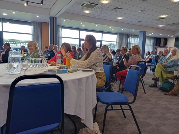 people in a room at tables for VCSA annual assembly 2023