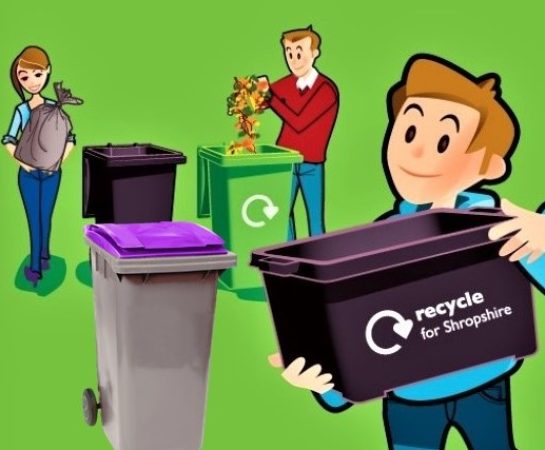 A family with a selection of wheelie bins and recycling boxes